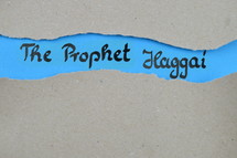 The Prophet Haggai - torn open kraft paper over blue paper with the name of the prophetic book Haggai