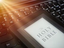 Close up of ebook reader with Bible 