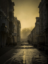 Foggy morning over a narrow side street in a city 