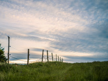 fence through a green rural landscape 