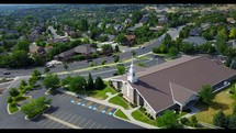 aerial view over a church parking lot 