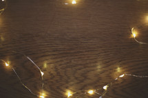 small lights form a border on a wood background