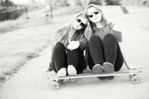 teen girls whose feet are on a skateboard 