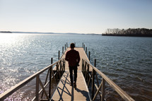 man walking on a floating dock 