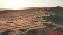 Beach with sand dunes at sunrise
