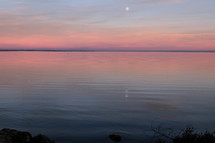 moon over a lake at sunrise 