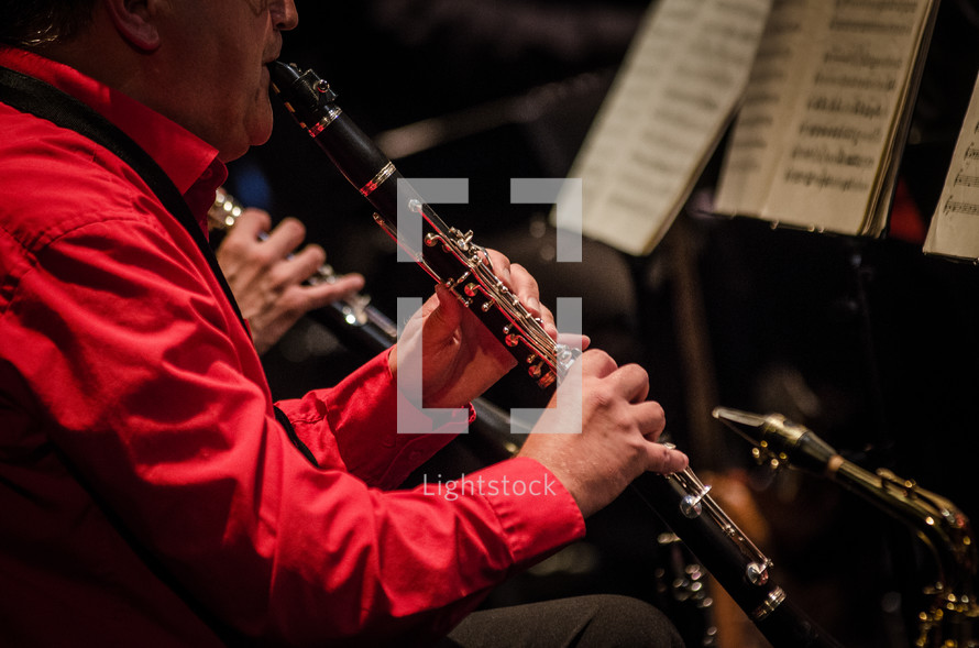 man playing a clarinet 