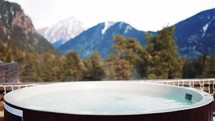 Pool with hot water on the background of snowy mountains. Premium mountain vacation and travel