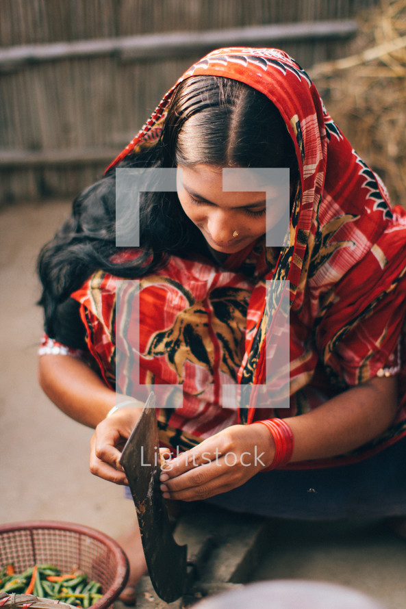 A woman chopping vegetables in Bangladesh 