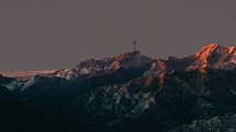 crucifix on mountain top at moonrise