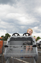 little boy in a shopping cart