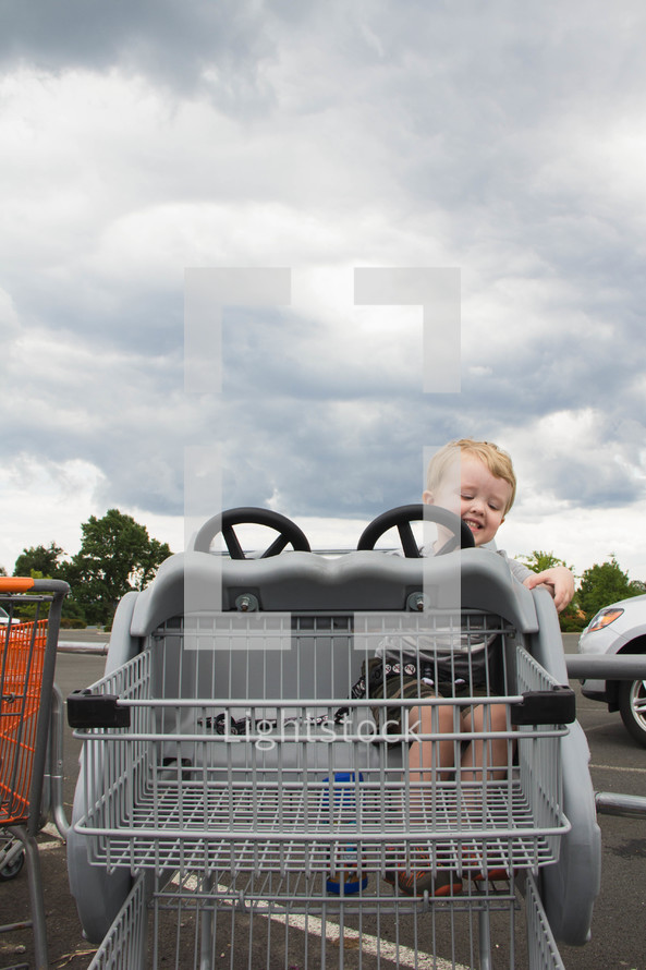 little boy in a shopping cart