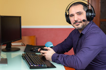 man with headphones playing videogames