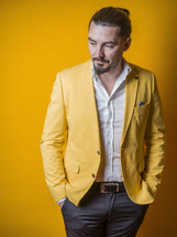 male model posing in a yellow blazer 