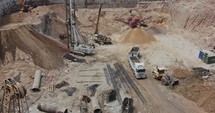 construction site time-lapse with trucks loaded and excavators working