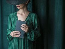 woman in green holding a Bible 