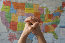 praying hands and map of the United States 