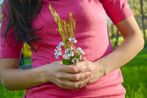 a woman holding picked flowers 