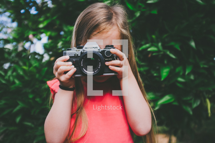 a child taking a picture with a camera 