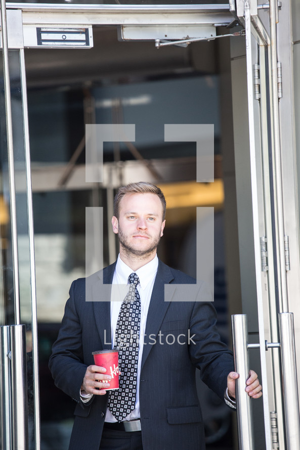 businessman holding a coffee cup 