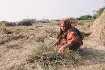 woman gathering straw 