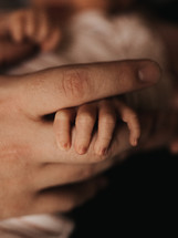 infant foot and mother's hand 