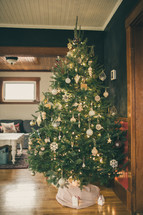 a decorated Christmas tree in a family room 