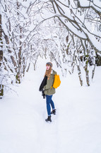 a woman standing outdoors in snow 