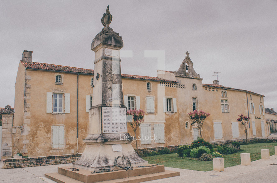 monument in front of an old building in France 