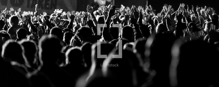 audience with raised hands 