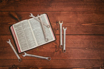wrenches on a Bible