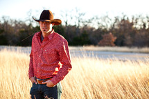 man in cowboy hat in a field