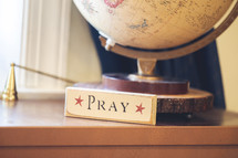 pray sign and globe 