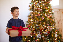 young boy giving a Christmas gift 