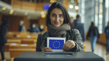 Confident woman casting her vote with a European Union ballot in a busy polling station, highlighting democratic participation.