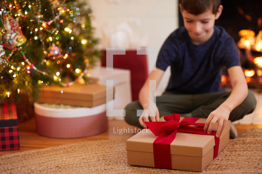 kid opening a Christmas gift 