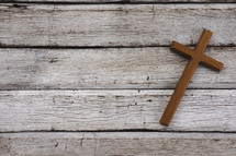 wooden cross on white wood boards 