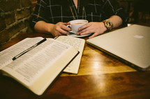 man reading a Bible and journaling 