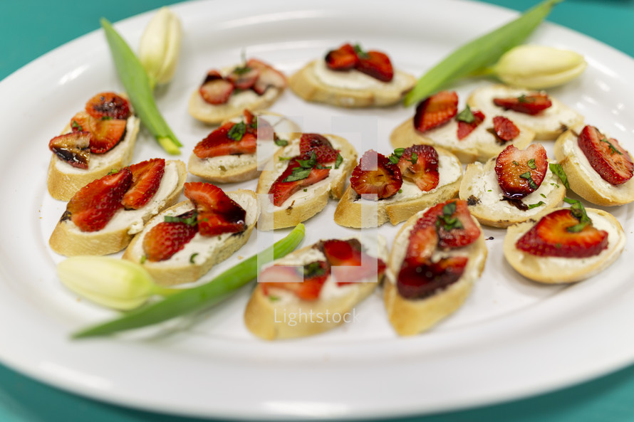 appetizer with strawberries and cream cheese on bread 