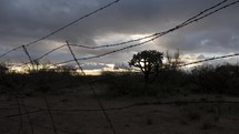 Timelapse of clearing rain clouds at sunrise at a ranch