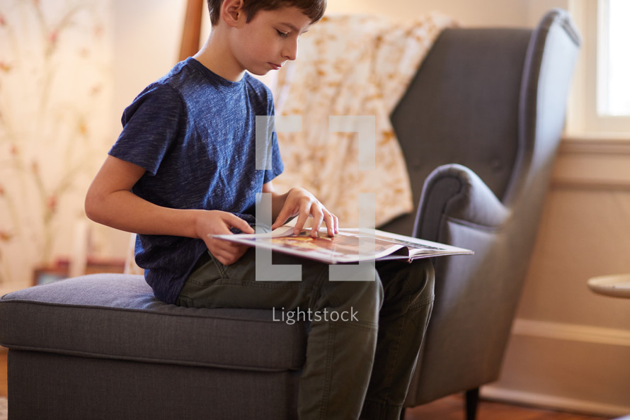 boy reading a book at home