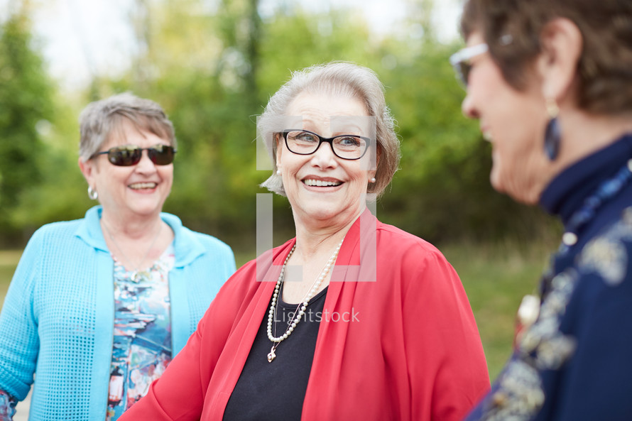 senior women talking outdoors 
