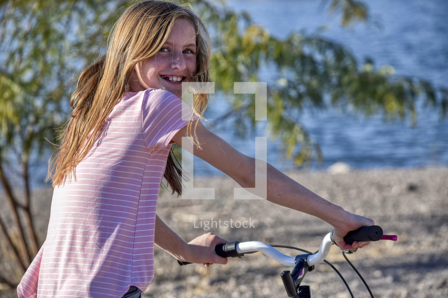 smiling girl on a bike 