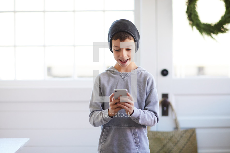 boy looking at a cellphone 