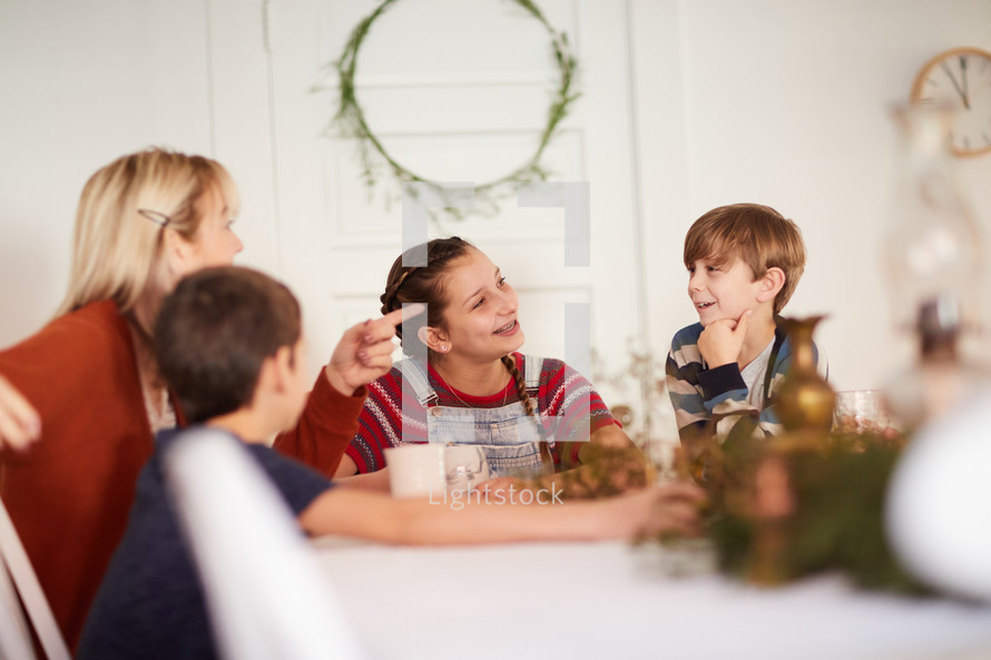family telling stories around a kitchen table 