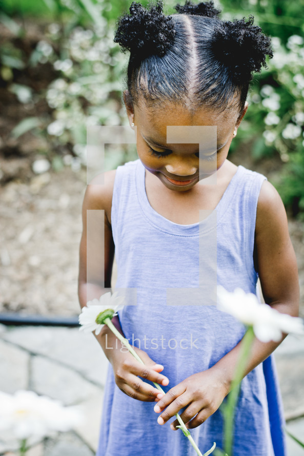 An African American girl holding a spring flowers 