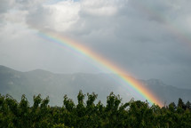 rainbow and rain over mountains 