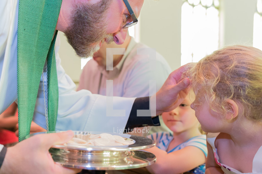 child receiving a blessing durning communion 