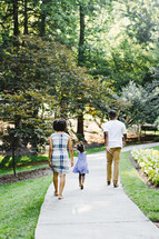 a family walking on a path outdoors in spring 