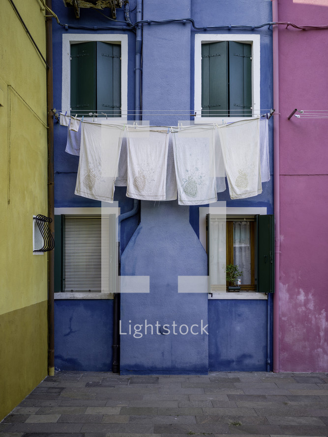 Clothesline outside of brightly colored homes